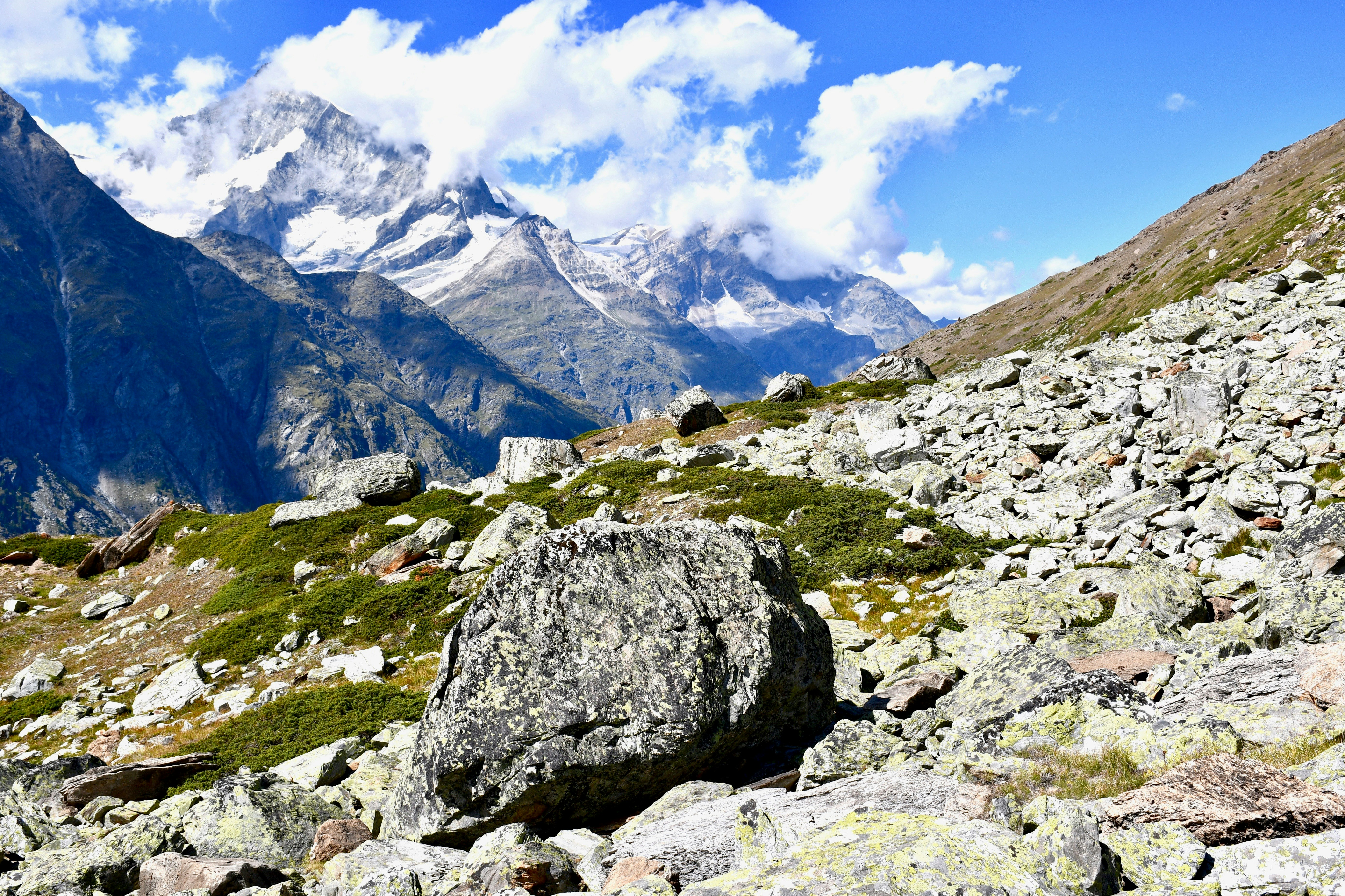 gray rocky mountain under white cloudy sky during daytime